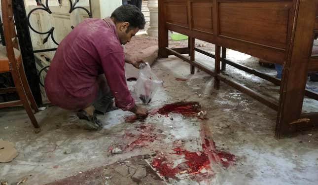 A worker cleans the scene inside the Cairo church following the Dec.11 bombing