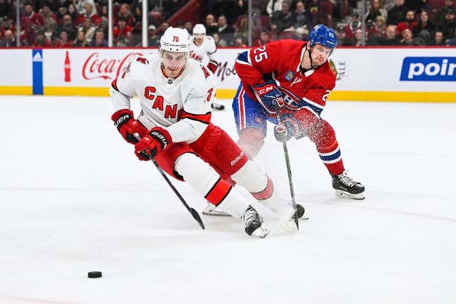 Apr 1, 2023; Montreal, Quebec, CAN; Carolina Hurricanes defenseman Brady Skjei (76) defends the puck against Montreal Canadiens right wing Denis Gurianov (25) during the first period at Bell Centre.
