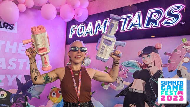 Kotaku's Alyssa Mercante holding bubble guns in front of a Foamstars-branded wall.