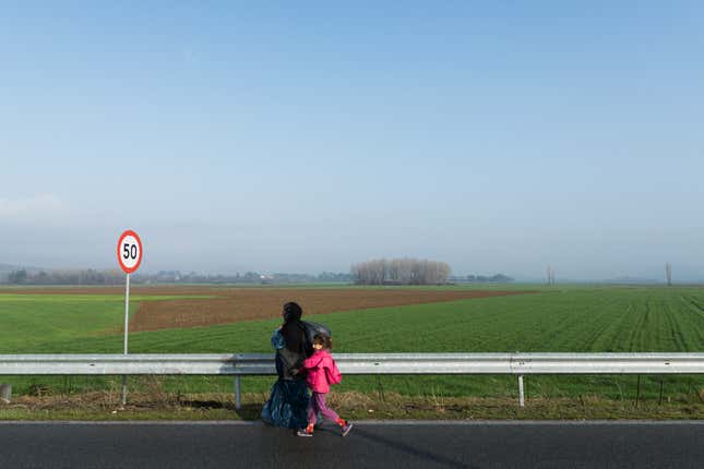 Mar. 1, 2016 – Idomeni, Greece. Refugees walk along the road leading into Idomeni, the Greek border village where over 8,000 refugees from Syria and elsewhere are waiting to cross.