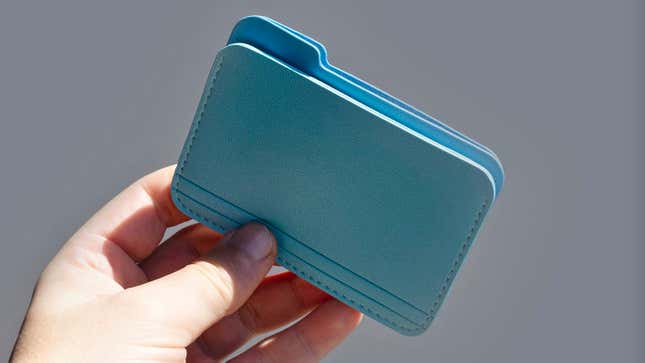 A hand holding Nikolas Bentel's Untitled Folder Wallet showing the various pockets.