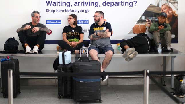 A photo of people sat waiting in an airport. 