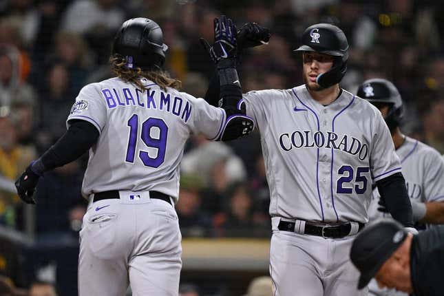 Mar 31, 2023; San Diego, California, USA; Colorado Rockies designated hitter Charlie Blackmon (19) is congratulated by first baseman C.J. Cron (25) after hitting a two-run home run during the fifth inning against the San Diego Padresat Petco Park.