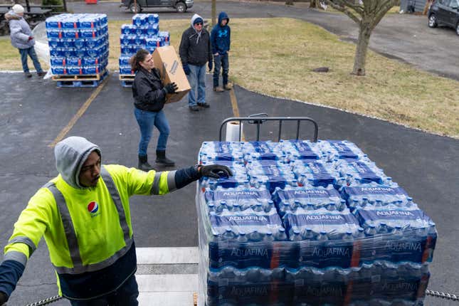 Dean Logan, a worker at Pepsi, delivers cases of water for volunteers to distribute to residents on February 17, 2023 in East Palestine, Ohio. 