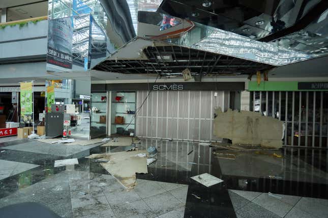 Broken glass and panels litter the floor at New Chitose Airport.