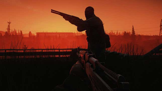 A hooded soldier points a rifle in front of a red sunset. 