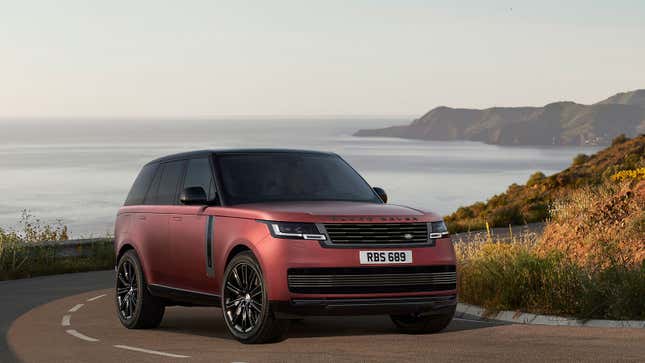A photo of a rend Range Rover on a coastal road. 