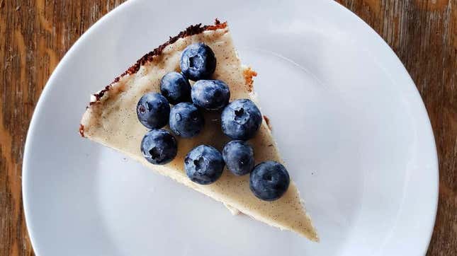 a slice of cheesecake topped with blueberries