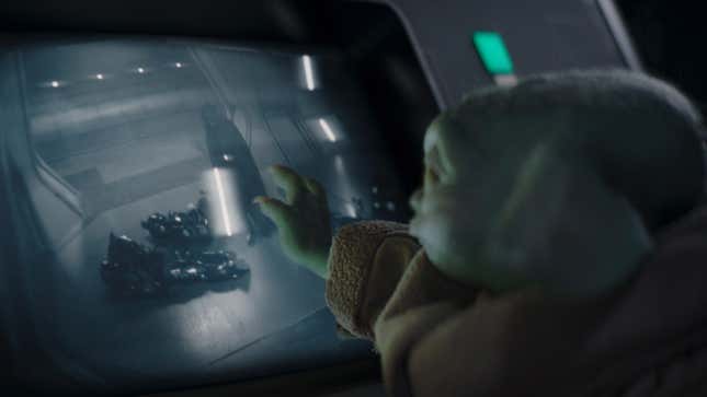 Baby Yoda, aka Grogu, touches a screen on The Mandalorian.