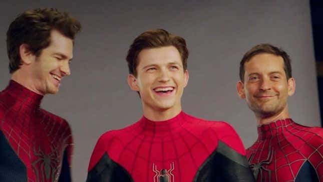 The three Spider-Men (Andrew Garfield, Tom Holland, Tobey Maguire) smile together.
