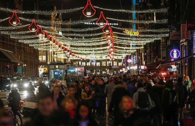 People walk in a shopping street in the center of Amsterdam, Netherlands, November 30, 2017.