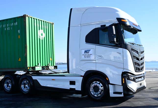 A Nikola EV for sale parked in Los Angeles with a green shipping crate on the bed. 