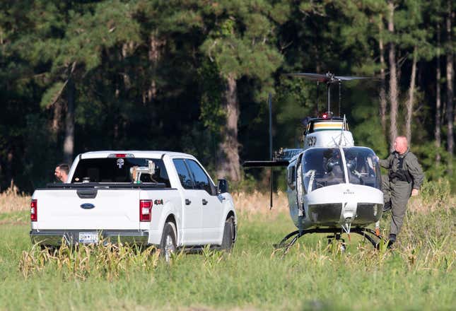 Pilots exit a Florence County Sheriff&#39;s Office helicopter after locating the position of a stealth fighter jet that crash-landed the previous day in a nearby field in Williamsburg County, S.C., on Monday, Sept. 18, 2023. (Henry Taylor/The Post And Courier via AP)