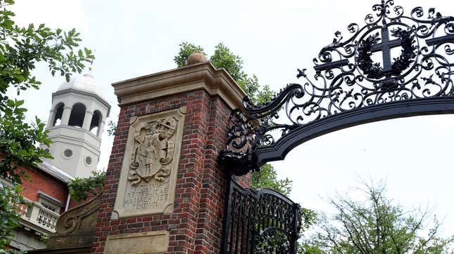 Iron and red brick gate Harvard University campus.