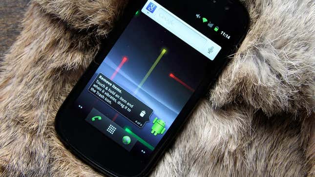 A photo of the Nexus S laying on what looks like fur displaying the original home screen for Android Gingerbread