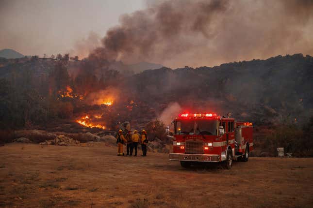 Firefighters stage in front of the Fairview Fire on Monday, Sept. 5, 2022, near Hemet, California. 
