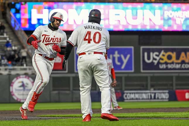 Apr 21, 2023; Minneapolis, Minnesota, USA; Minnesota Twins infielder Joey Gallo (left) celebrates his solo home run against the Washington National with third base coach Tommy Watkins (40) during the third inning at Target Field.