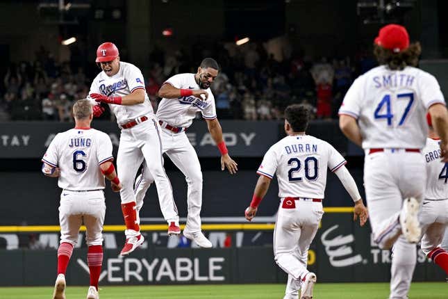 Jun 5, 2023; Arlington, Texas, USA; The Texas Rangers run on to the field after first baseman Nathaniel Lowe (30) drives in the game winning run against the St. Louis Cardinals during the ninth inning at Globe Life Field.