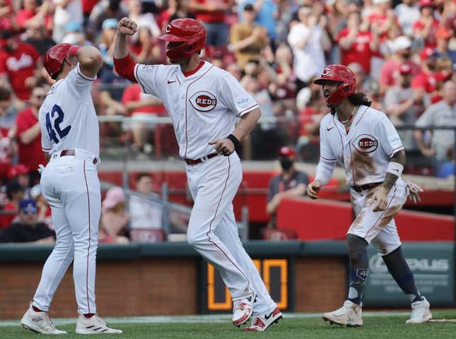 Apr 15, 2023; Cincinnati, Ohio, USA; Cincinnati Reds first baseman Wil Myers (middle) reacts with third baseman Spencer Steer (left) and second baseman Jonathan India (right) after hitting a three-run home run against the Philadelphia Phillies during the third inning at Great American Ball Park.