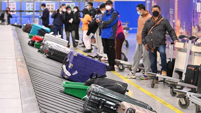 A photo of bags on a conveyor at an airport. 