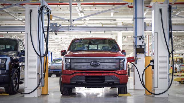 A photo of a Ford F-150 Lightning truck charging at a factory.