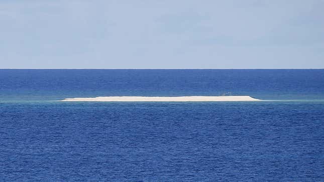 In this Friday, April 21, 2017 photo, a sandbar is seen from the Philippine-claimed Thitu Island off the disputed South China Sea in western Philippines. On Tuesday, Aug. 22, 2017, two Filipino security officials said China has deployed its navy and coast guard ships in a cluster of uninhabited sandbars in the disputed South China Sea amid concerns that the Philippines may build structures on them in an emerging territorial issue that the government stated was quickly resolved.