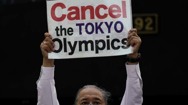 A protester holds up a banner calling for the Olympic Games to be canceled