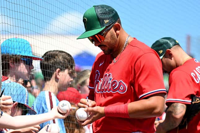 March 17, 2023;  Clearwater, Florida, USA;  Designated hitter Derrick Hall (24) of the Philadelphia Phillies signs autographs prior to a spring training game against the Toronto Blue Jays at Bayacre Ballpark.