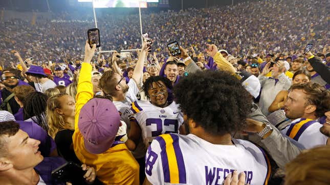 LSU fans stormed the field after the Tigers defeated rival Alabama in OT