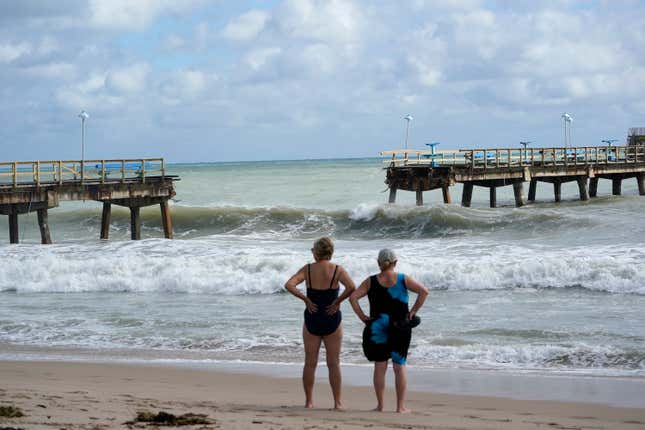 Photo of two people facing collapsed pier