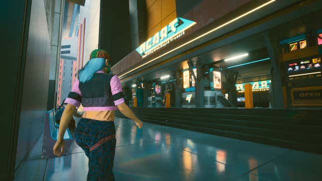 A Night City citizen walks toward a Night City metro station in Cyberpunk 2077.