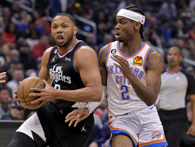 Mar 23, 2023; Los Angeles, California, USA; Los Angeles Clippers guard Eric Gordon (10) has the ball stropped by Oklahoma City Thunder guard Shai Gilgeous-Alexander (2) as he moves to the basket in the first half at Crypto.com Arena.