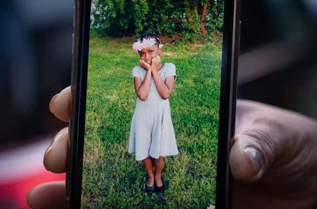 A relative holds up a cell phone with a photo of Fanta Bility. Fanta, 8, who was killed in Sharon Hill during a shooting on Aug. 27.