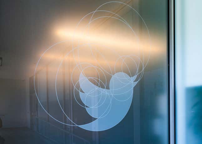 The Twitter logo of a blue bird on the window of the Los Angeles corporate offices.