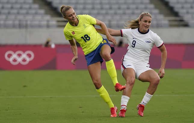 Sweden forward Fridolina Rolfo (18) collides with United States midfielder Lindsey Horan (9) during the first half in Group G play during the Tokyo 2020 Olympic Summer Games at Tokyo Stadium.