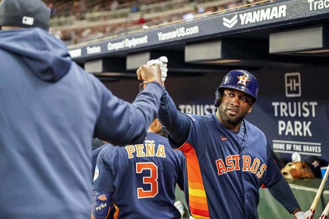 Apr 22, 2023; Cumberland, Georgia, USA; Houston Astros designated hitter Yordan Alvarez (44) reacts in the dugout with manager Dusty Baker (12) after hitting a two run home run against the Atlanta Braves during the sixth inning at Truist Park.