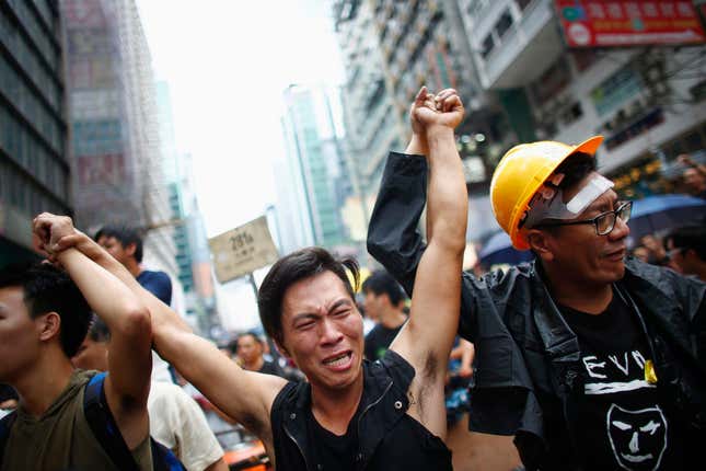 A pro-democracy protester cries after scuffles anti-protesters at a protest site in Mong Kok.