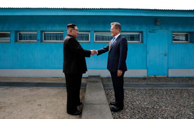 North Korean leader Kim Jong-un shakes hands with South Korean president Moon Jae-in between the military demarcation line in of Panmunjom on Apr. 27, 2018.