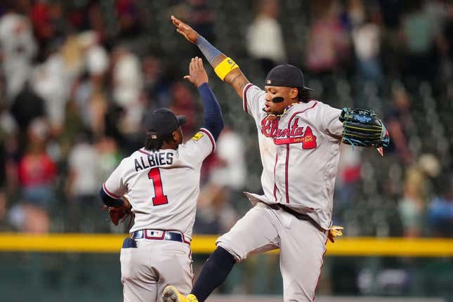 Aug 29, 2023; Denver, Colorado, USA; Atlanta Braves right fielder Ronald Acuna Jr. (13) and second baseman Ozzie Albies (1) celebrate defeating the Colorado Rockies at Coors Field.
