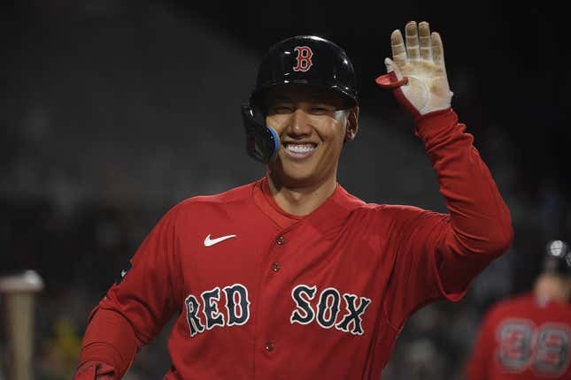 May 2, 2023; Boston, Massachusetts, USA;  Boston Red Sox designated hitter Masataka Yoshida (7) high fives a teammate after hitting a home run during the fourth inning against the Toronto Blue Jays at Fenway Park.