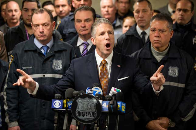 Patrolmen’s Benevolent Association President Patrick J. Lynch, left, speaks with the media at the Bronx Criminal Court after NYPD Lt. Jose Gautreaux, who was shot in the arm by a gunman who opened fire in a police precinct in the Bronx, was released from Lincoln Hospital, Monday, Feb. 10, 2020, in New York.