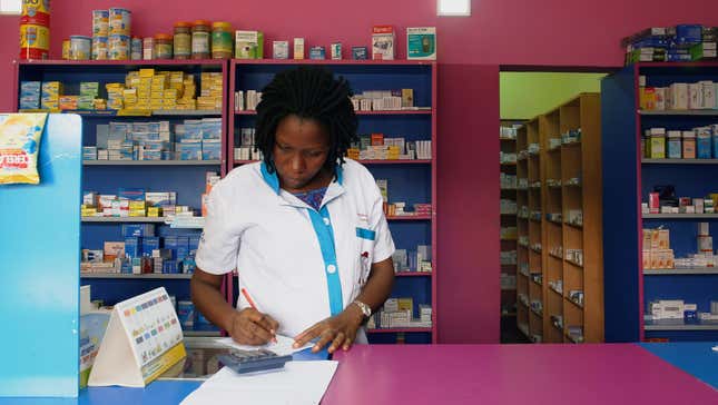 A vendor writes as she stands in a legal pharmacy in Abidjan, Ivory Coast