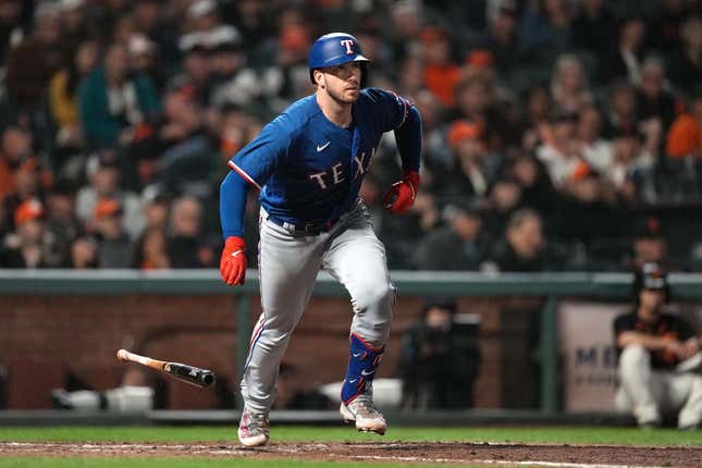 Aug 12, 2023; San Francisco, California, USA; Texas Rangers catcher Mitch Garver (18) runs to first base after hitting an RBI single against the San Francisco Giants during the ninth inning at Oracle Park.