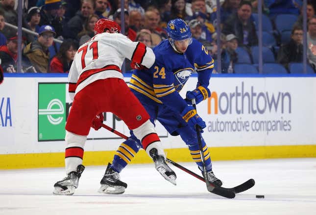 Apr 8, 2023; Buffalo, New York, USA;  Carolina Hurricanes right wing Jesper Fast (71) and Buffalo Sabres center Dylan Cozens (24) go after a loose puck during the first period at KeyBank Center.