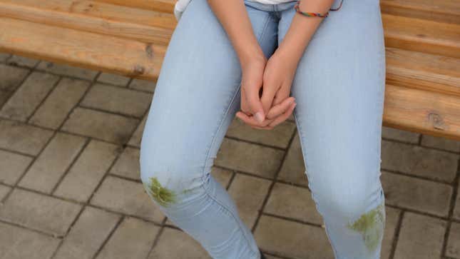 Young girl with grass stains on her jeans.
