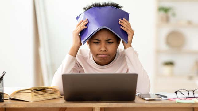 Girl looking at laptop with frustrated expression