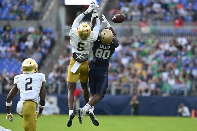 Nov 12, 2022; Baltimore, Maryland, USA;  Notre Dame Fighting Irish cornerback Cam Hart (5) breaks up a pass intended for Navy Midshipmen wide receiver Mark Walker (80) during the second half at M&amp;amp;T Bank Stadium.