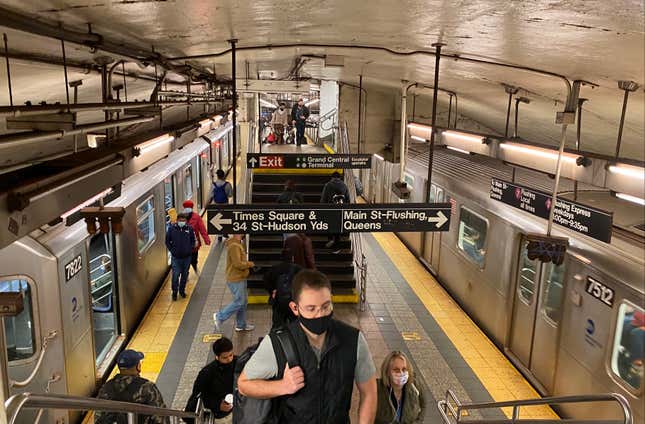 Passengers enter and exit subway cars at Grand Central Terminal subway station.