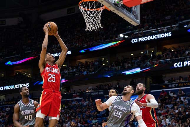 Apr 4, 2023; New Orleans, Louisiana, USA;  New Orleans Pelicans guard Trey Murphy III (25) dunks the ball against Sacramento Kings center Alex Len (25) during the second half at Smoothie King Center.