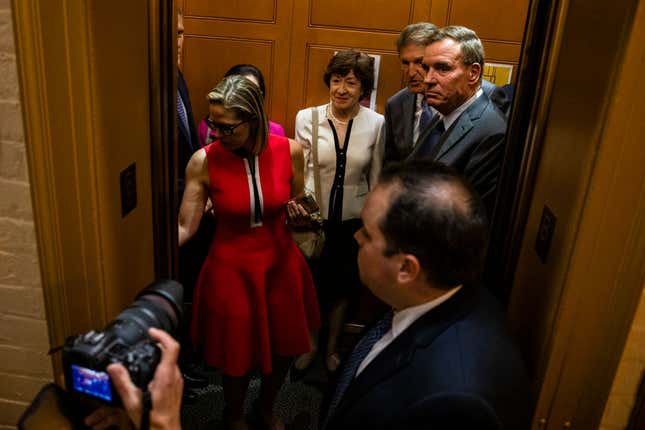 U.S. Sen. Kyrsten Sinema (D-AZ), U.S. Sen. Susan Collins (R-ME), U.S. Sen. Joe Manchin (D-WV), and U.S. Sen. Mark Warner (D-VA) board an elevator on their way to cast a vote in the Senate following a bipartisan meeting on infrastructure in the basement of the U.S. Capitol building after initial talks fell through with the White House on June 8, 2021, in Washington, DC. Senate Majority Leader Chuck Schumer (D-NY) said they are now pursuing a two-path proposal that includes a new set of negotiations with a bipartisan group of senators.